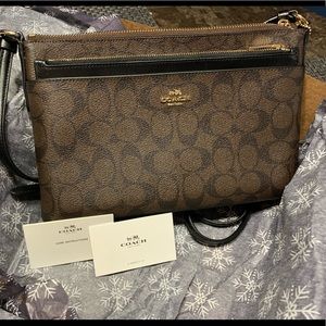 Coach, brown and black, crossbody. Never used. Excellent condition.